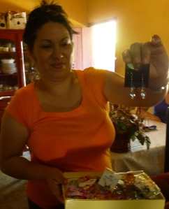 Blanca shows off earrings and other jewelry that she makes from home. 